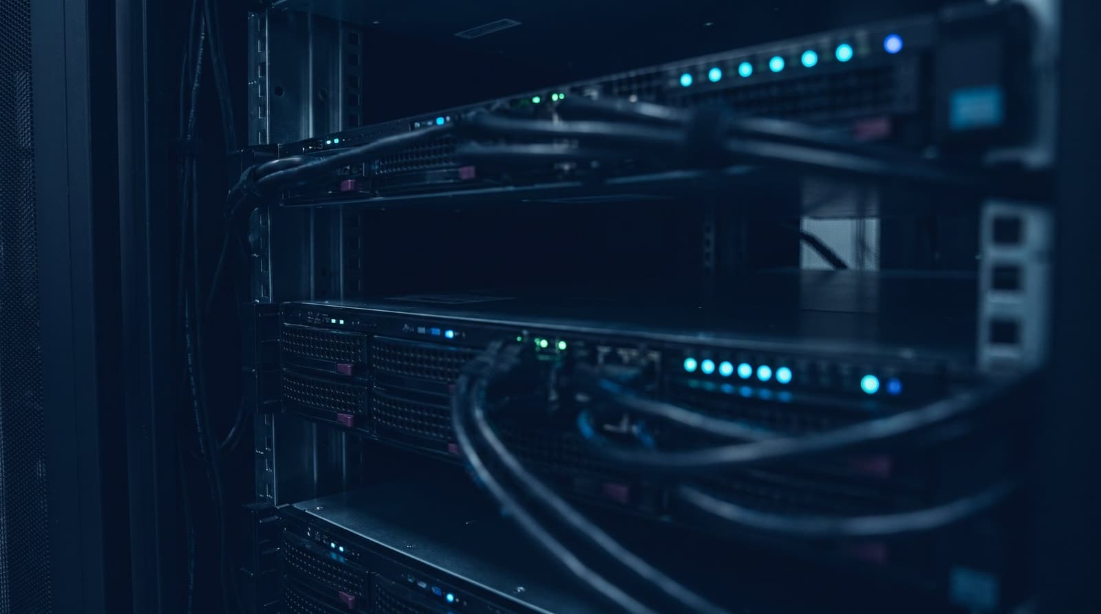 Status lights glowing inside a dark server rack
