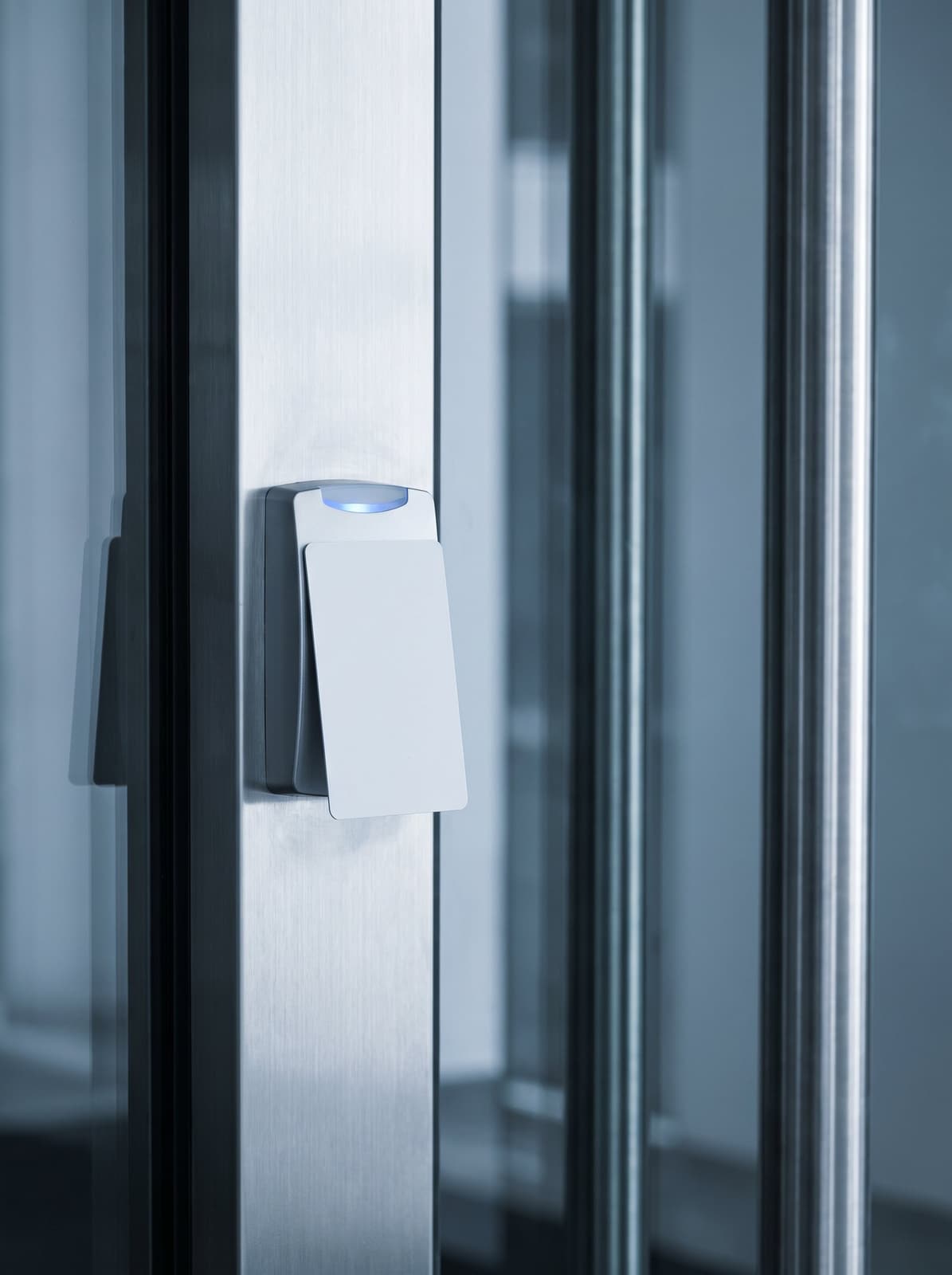 Access control reader beside a glass security door